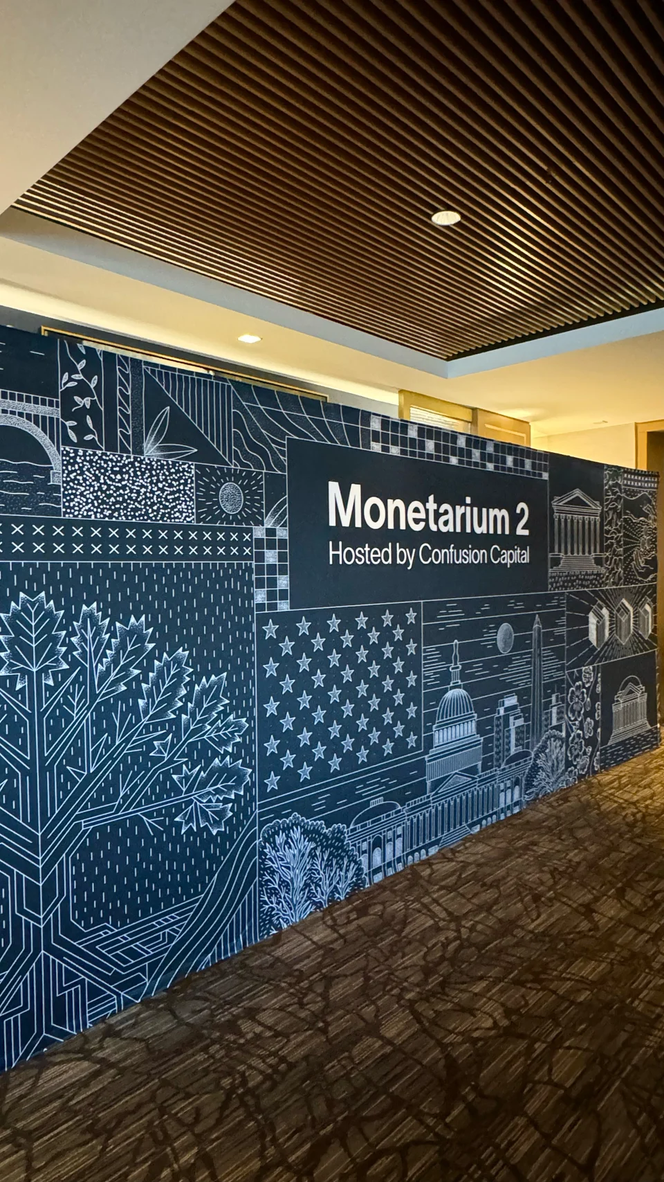 Monetarium 2025 photowall installed at the event, original uncropped photograph